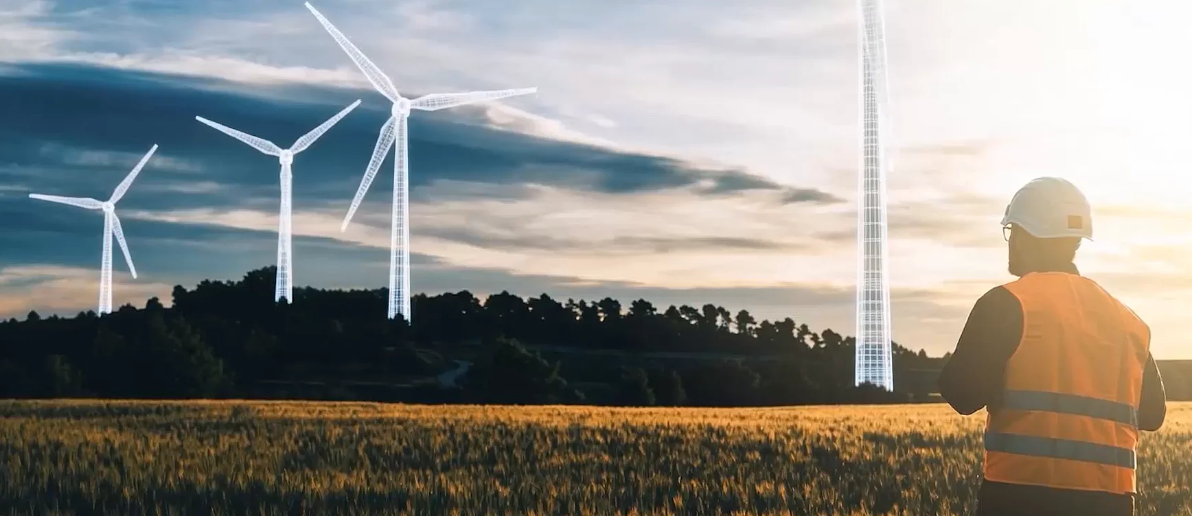 Bauarbeiter blickt auf Windkraftanlagen – von virtueller Planung zur realen Umsetzung